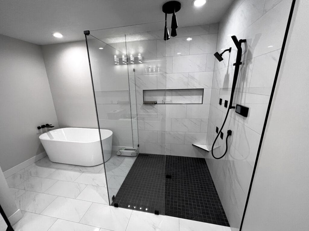 Luxury walk-in shower with professional tile installation in a modern bathroom remodel.