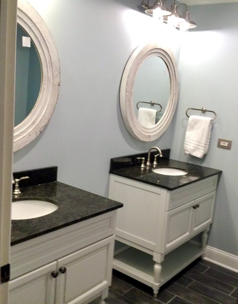Bathroom lighting upgrade with double mirrors, modern vanity fixtures, and new wall lighting — part of a custom bathroom remodeling project in Utah.