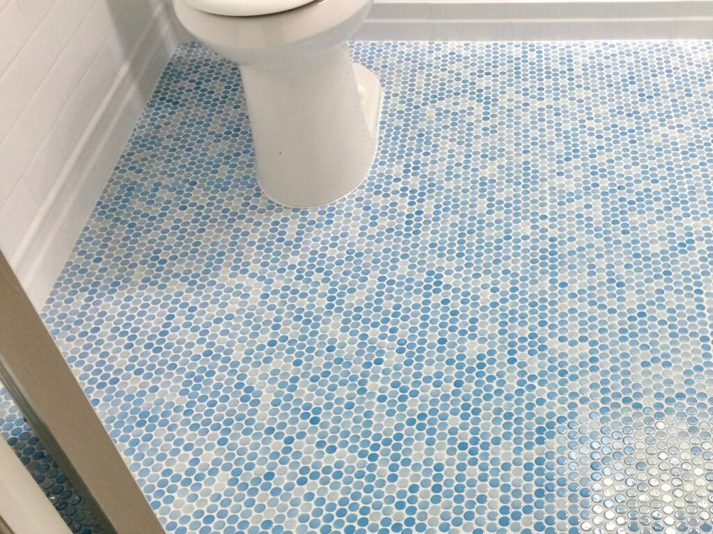 Blue and white penny tile bathroom floor installed with premium materials