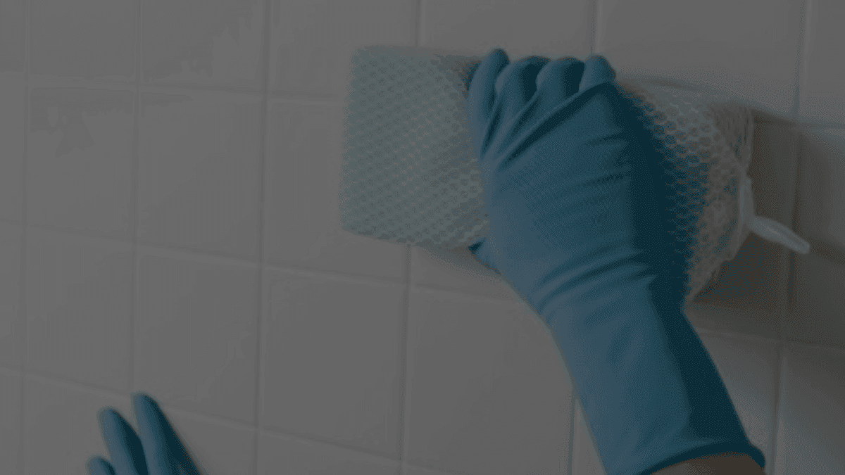 Cleaning ceramic tiles with a sponge for spotless kitchen, bathroom, or patio surfaces.