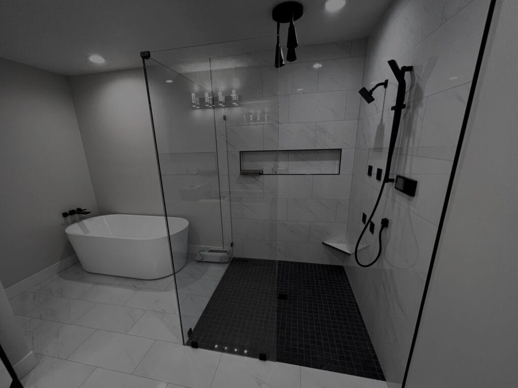 Luxury walk-in shower with professional tile installation in a modern bathroom remodel.